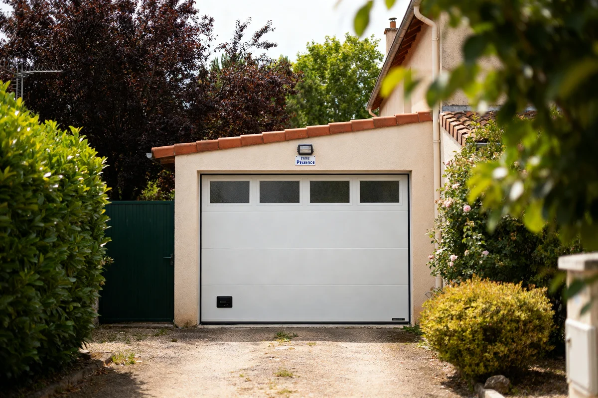 Garage moderne avec porte électrique blanche, découvrez le prix porte de garage electrique optimal